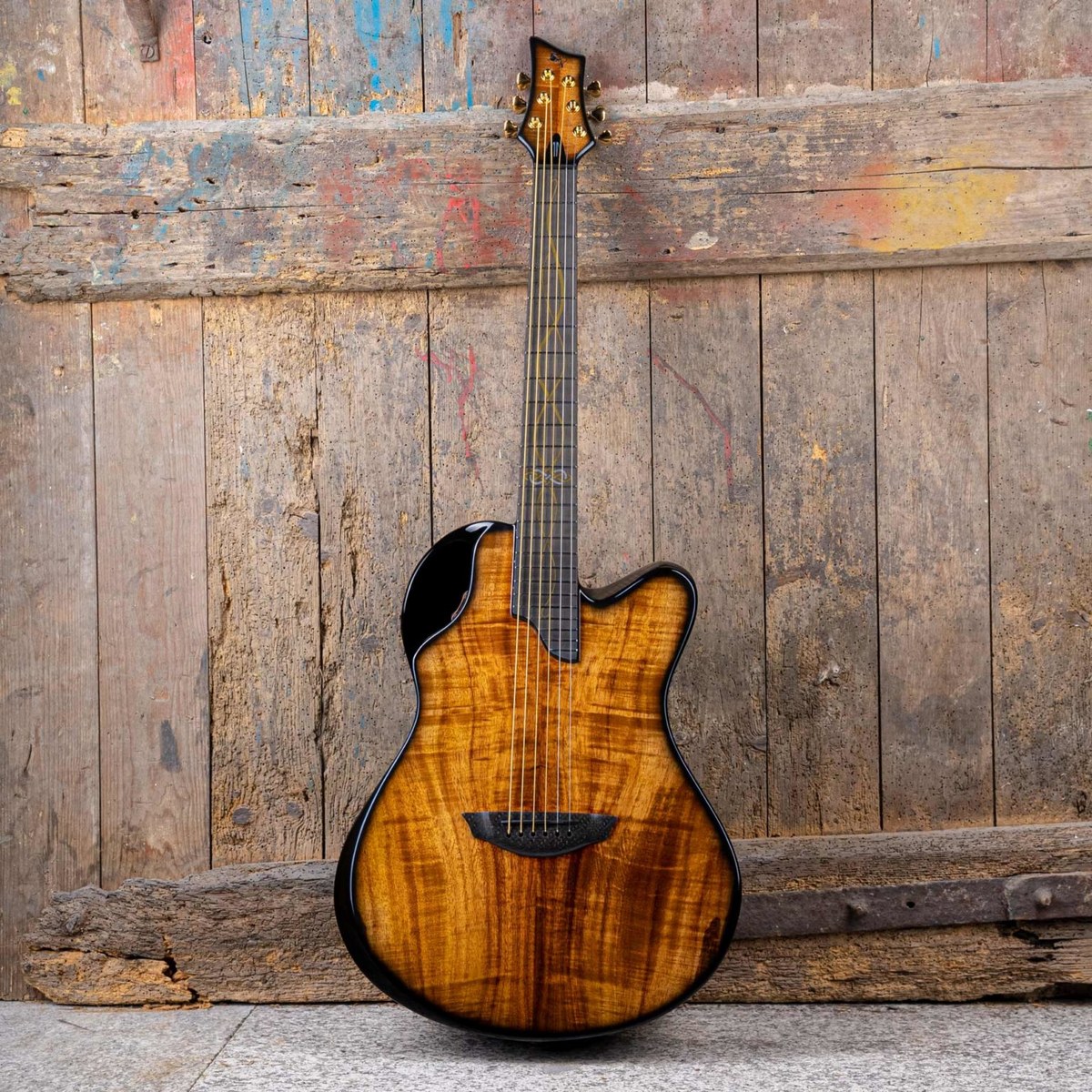 Emerald X20 guitar showcasing wood grain against textured backdrop