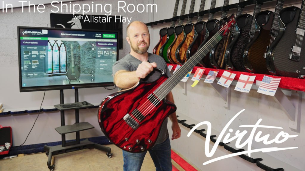 Alistair Hay in guitar shipping room holding a Virtuo model