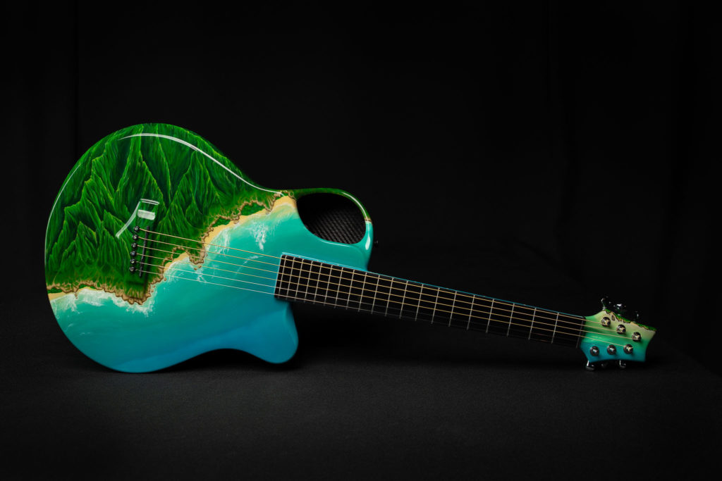 Jessica hand painting an Emerald Guitar