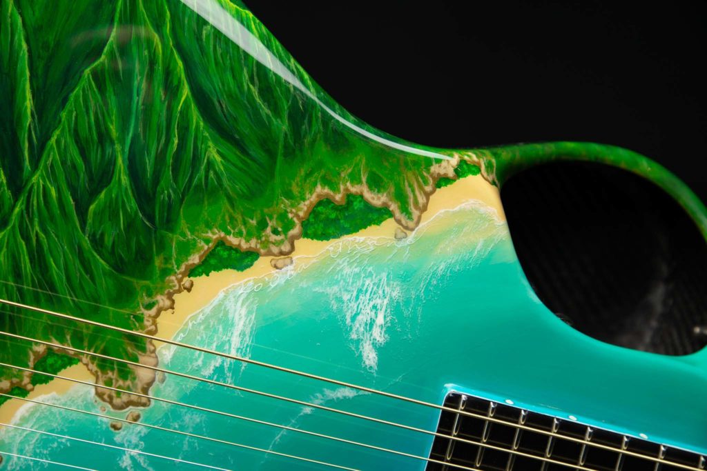 Kahi Ko’ola Uhane hand painted into the waves on the Emerald guitar