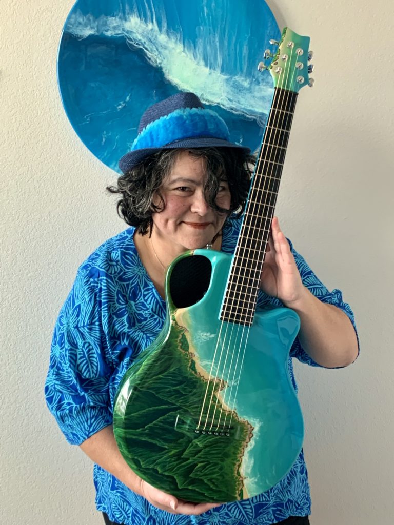 Staci Belvins holding her Emerald guitar