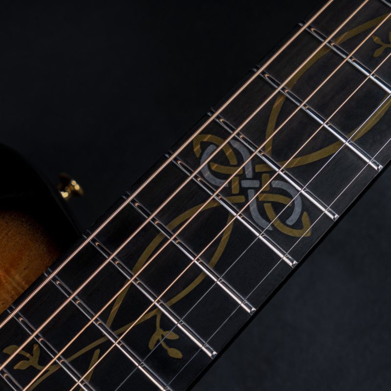 Close-up of X10 Koa guitar fretboard