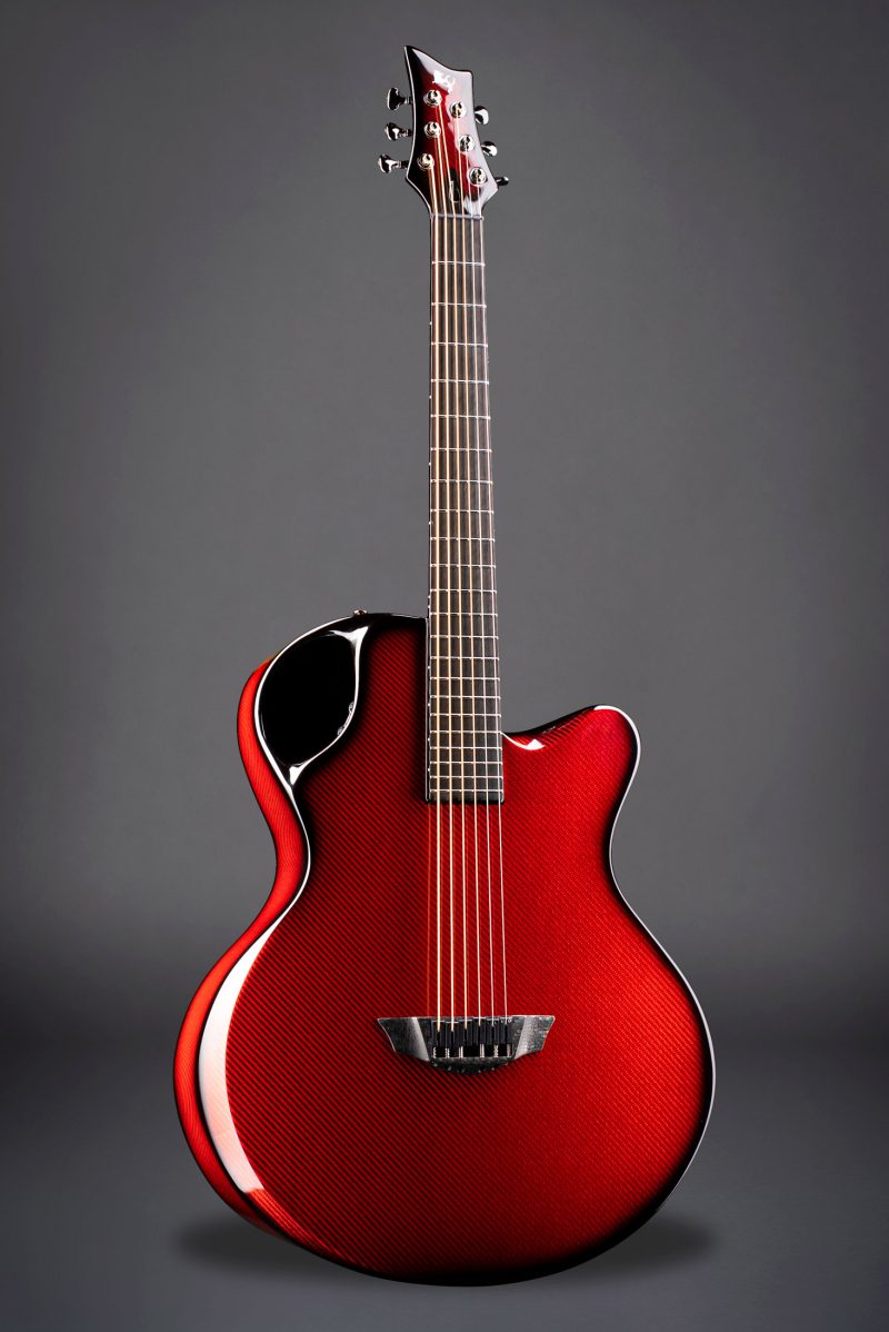 Striking red Emerald Guitars X30 with a distinctive carbon fiber pattern, offering premium sound quality
