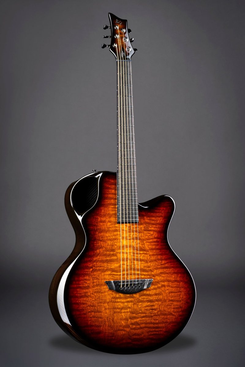 Emerald X30 guitar in striking amber Tamo Ash, blending natural wood beauty with resilient carbon fiber technology.