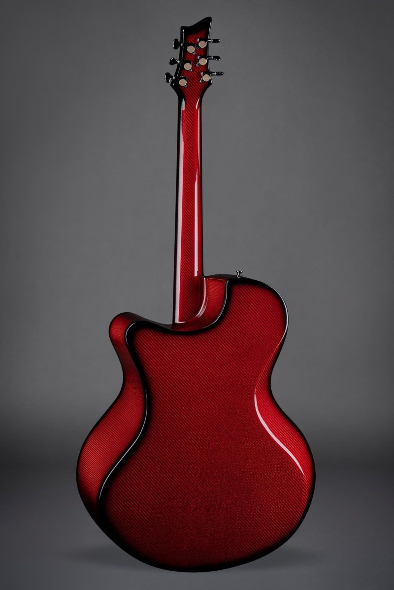 Back view of the Emerald X30 guitar in vibrant red showcasing the carbon fiber weave construction