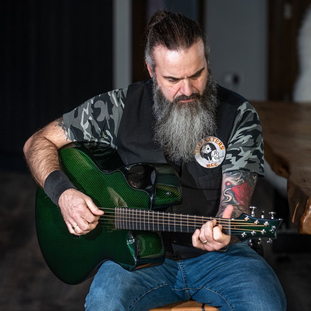 Davy K playing an Emerald X30 acoustic carbon fiber guitar