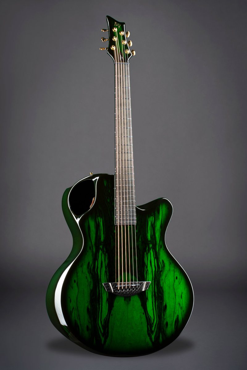Front view of Emerald X30 guitar with vibrant green color and detailed carbon weave body