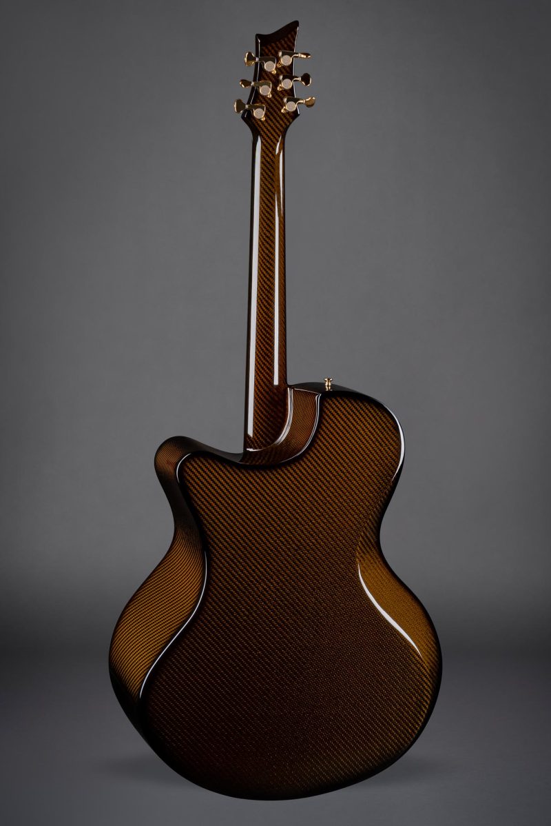 Rear view of Emerald X30 Cocobolo guitar highlighting the warm amber tones and wood texture