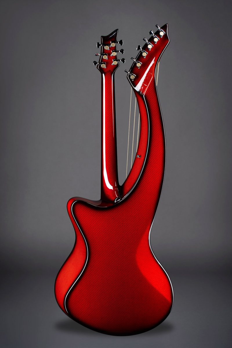 Rear view of Emerald Synergy X20 guitar showcasing the vibrant red finish and carbon weave texture