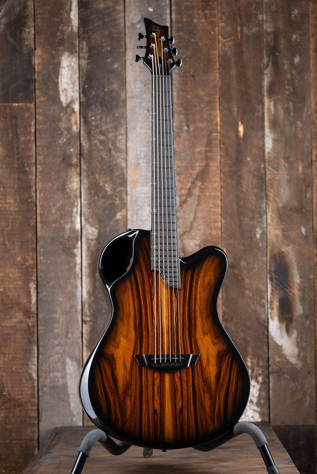 Emerald X20 guitar in wood finish carbon fiber against rustic background
