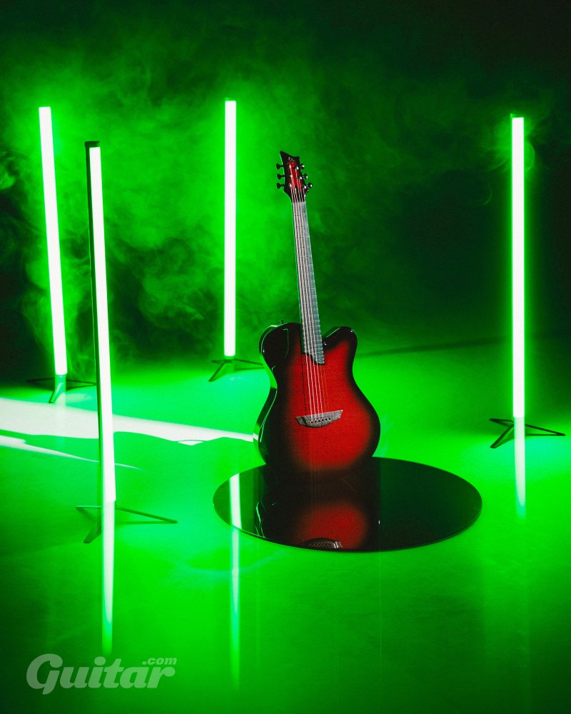 X20 carbon fiber guitar surrounded by lights in cool green smoky display